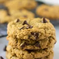 Multiple oatmeal chocolate chip cookies stacked up on each other.