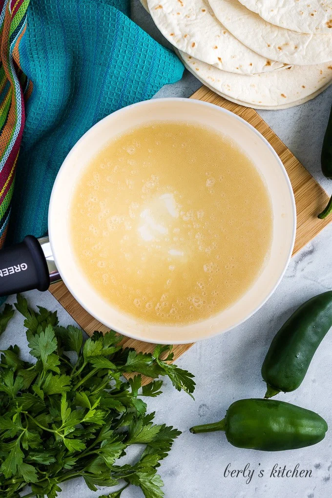 The flour and oil cooking in a medium sized saucepan.