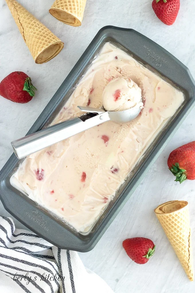 The finished dessert being scooped out of a loaf pan.