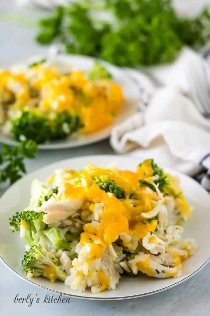 Instant pot chicken broccoli rice on white plates.