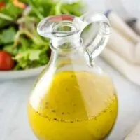 A glass cruet filled with the finished homemade italian dressing.