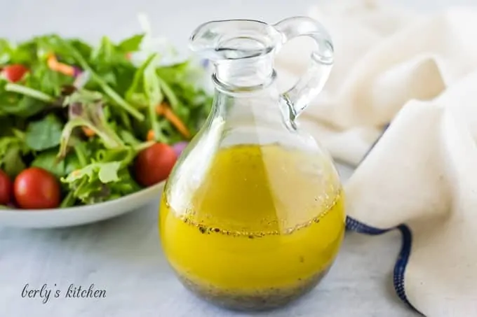 The homemade salad dressing recipe served in a glass cruet.