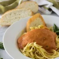 The finished marinara sauce poured over a bowl of pasta.