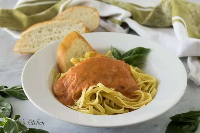 A bowl of spaghetti noodles topped with the marinara sauce.