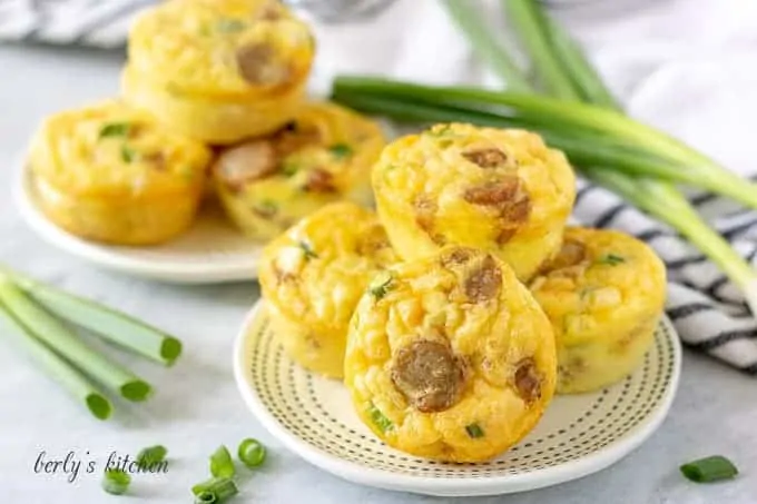 Eight of the sausage egg and cheese muffin cups on a plate.