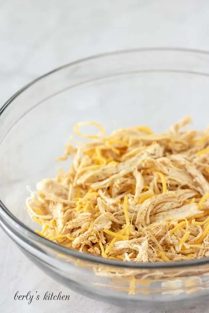 Shredded cheese has been combined with the meat and spices.