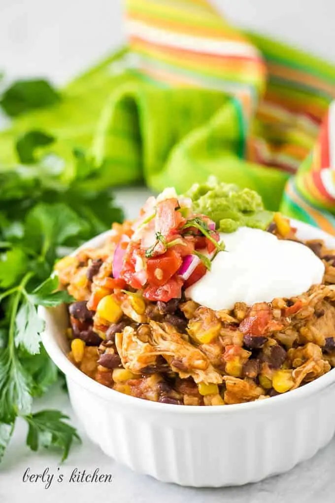 A ramekin of the chicken taco bowls topped with guacamole.