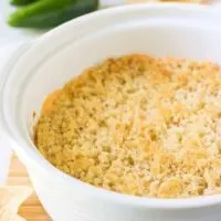 The finished popper dip served in a white casserole dish.