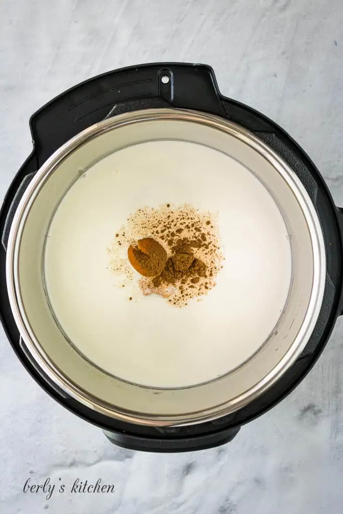 Milk, cream, and spices added to the pressure cooker liner.