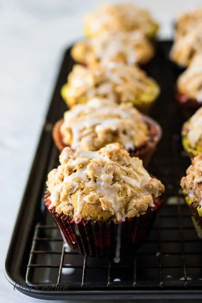 A close up of a muffin topped with streusel and glaze.