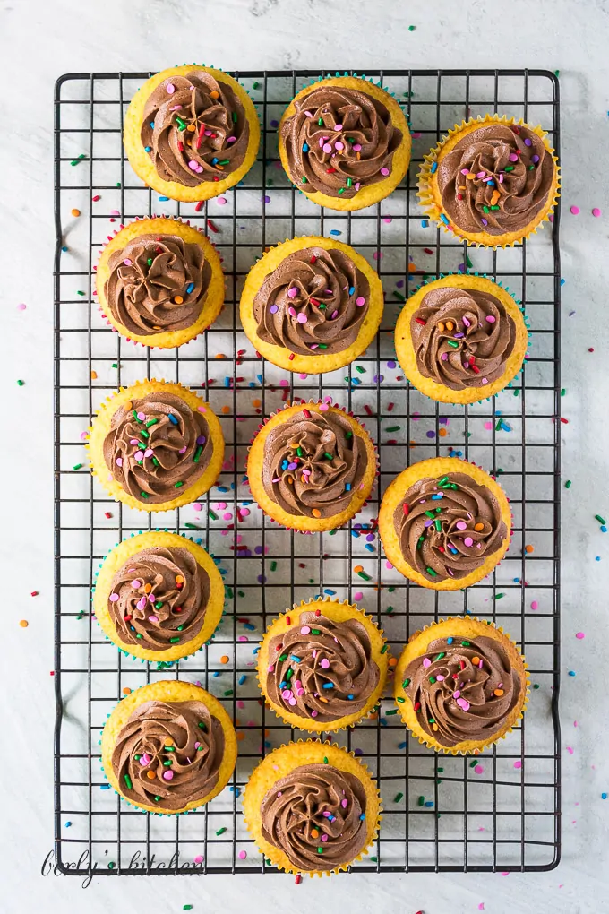 Top down view of the decorated cupcakes on a rack.