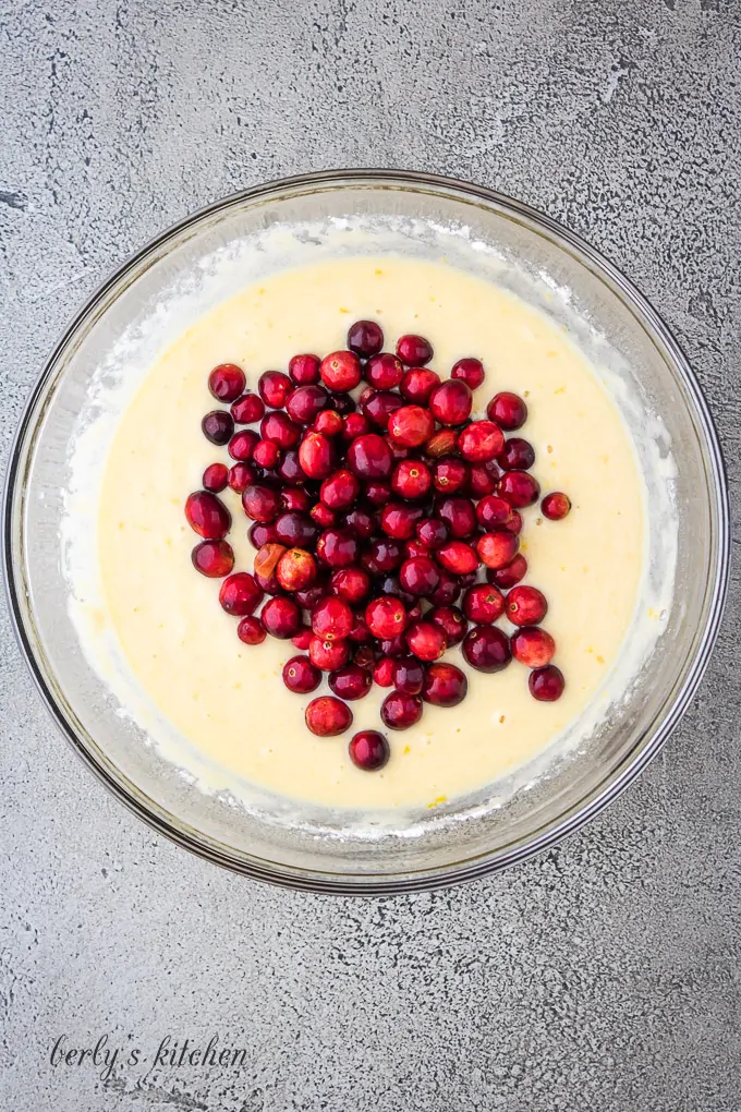 The muffin batter has been mixed and fresh cranberries added.