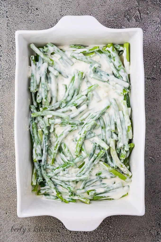 The sauce has been poured over the vegetables in the baking dish.