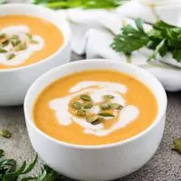 The instant pot acorn squash soup drizzled with coconut milk.