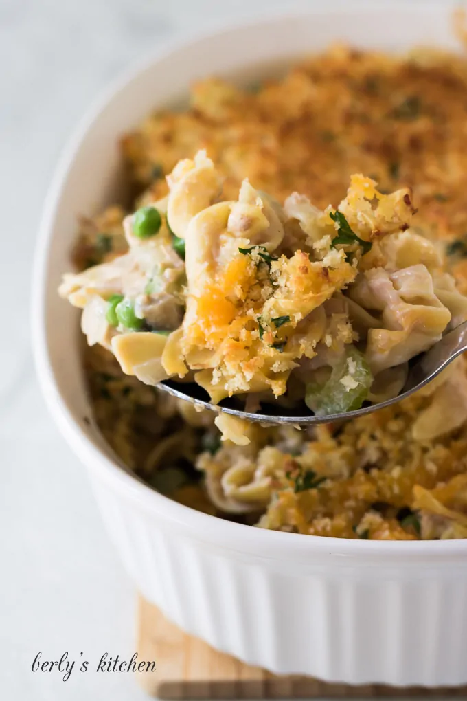 A spoon scooping out a portion of the tuna casserole.