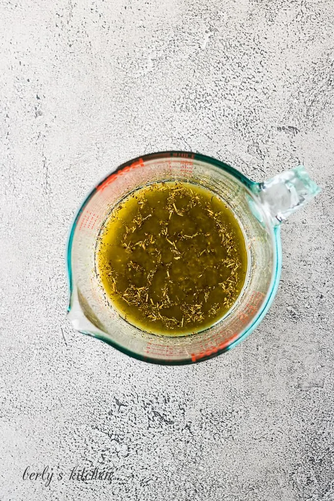 The melted butter and spices in a glass measuring cup.