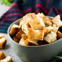 A close-up of the finished croutons in a green bowl.