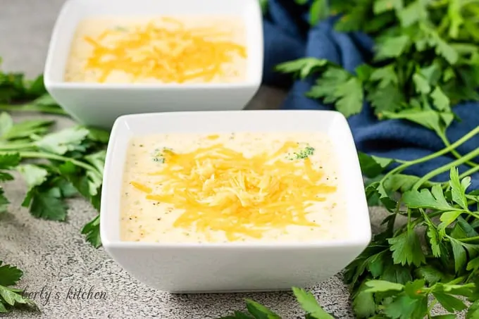 The instant pot broccoli cheese soup served in square bowls.