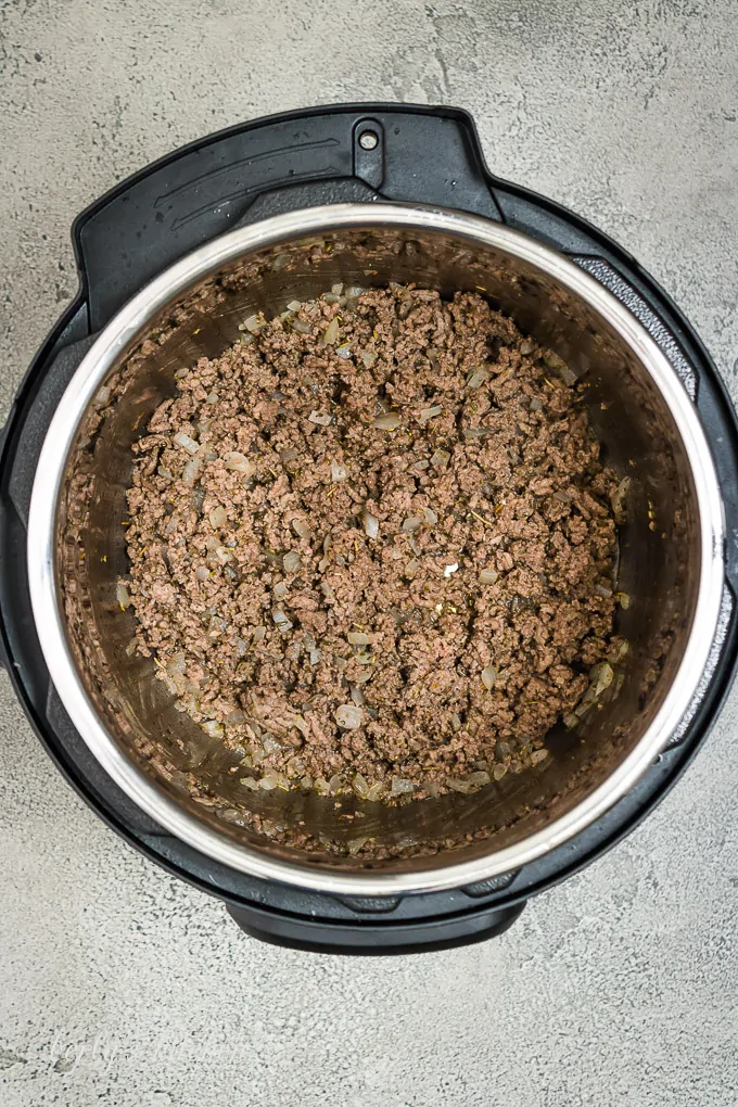 Ground beef and other ingredients sauteed in the pressure cooker.