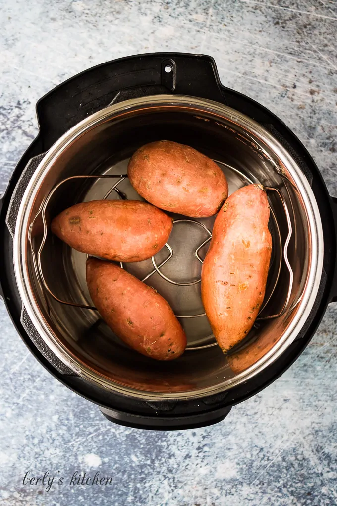 The prepped taters on a trivet in the pressure cooker.