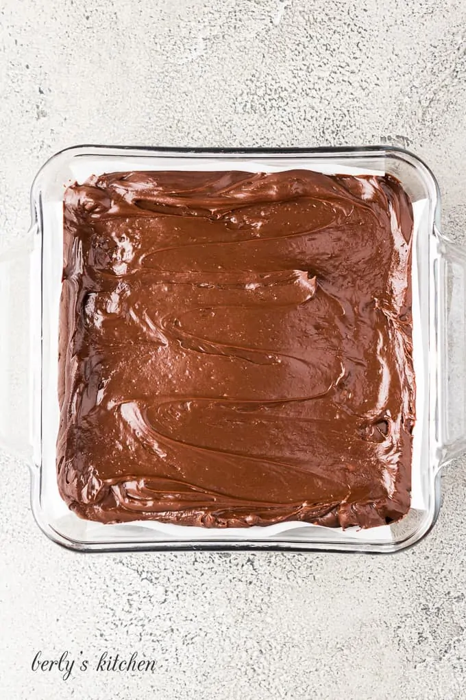 The fudge has been transferred to a prepared casserole dish.