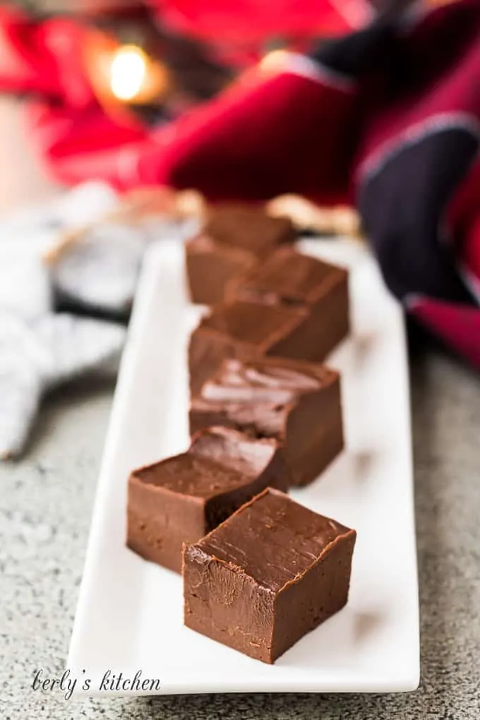 Multiple pieces of irish cream fudge on a decorative plate.