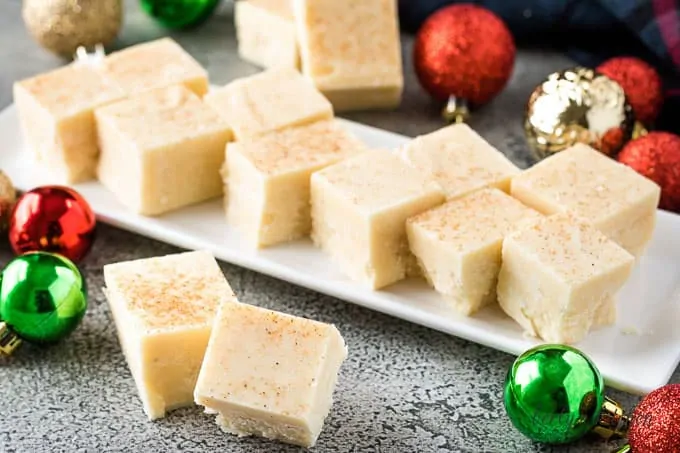 Multiple pieces of eggnog fudge on a plate.