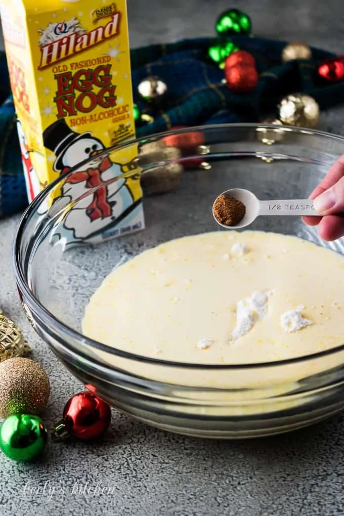 Nutmeg being added to the mixing bowl with the pudding mixture.