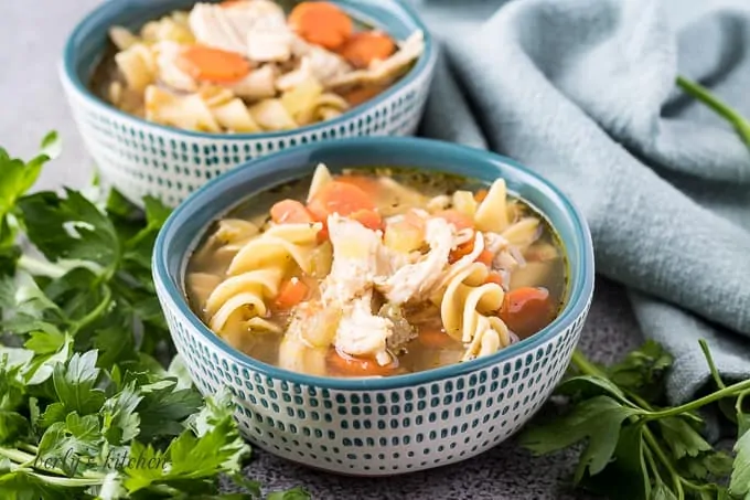 Two decorative bowls of the instant pot chicken noodle soup.