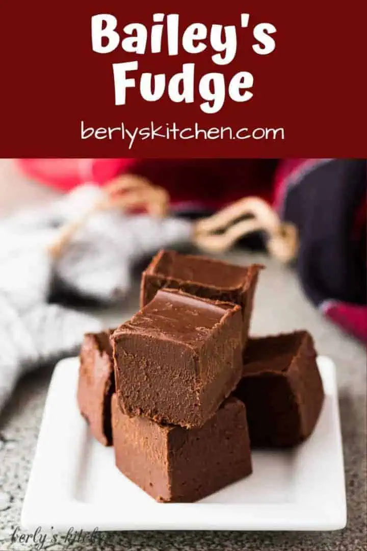 Pieces of baileys fudge stacked on a small square plate.