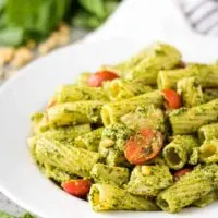 The finished chicken pesto pasta in a large decorative bowl.