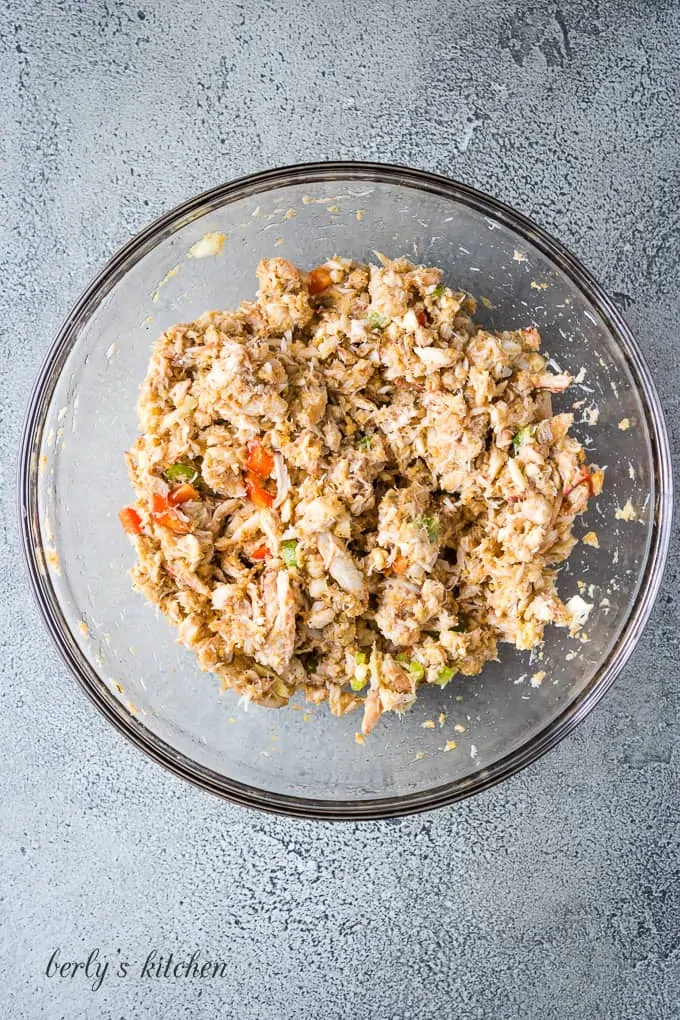 The crab cake ingredients have been mixed in the bowl.