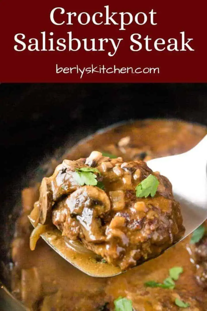 A crockpot salisbury steak being lifted by a metal spatula.