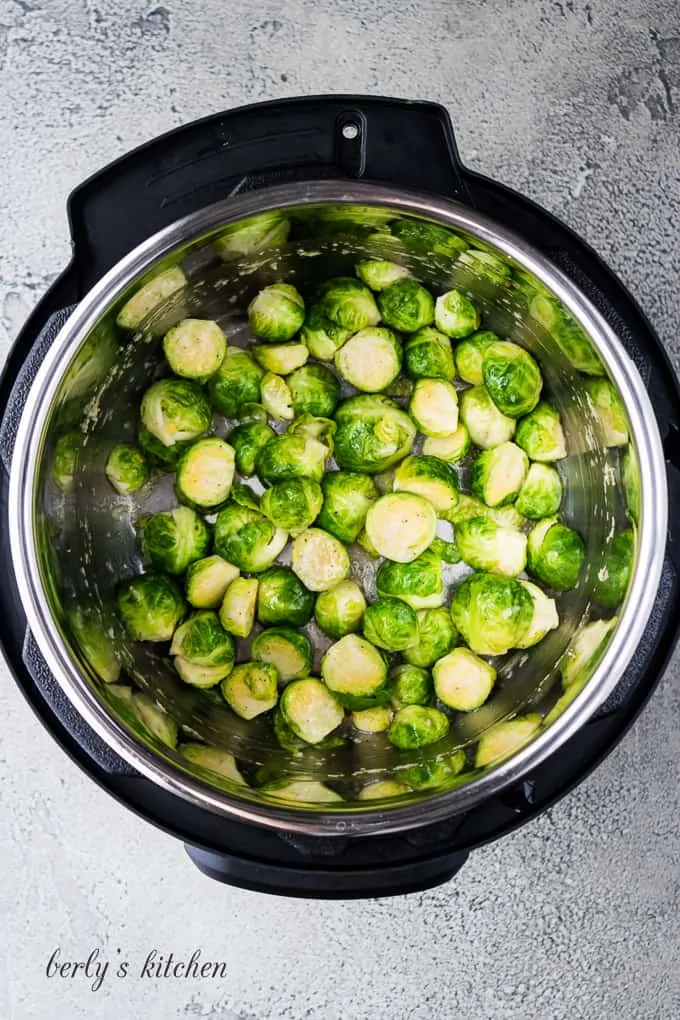 The cooked brussel sprouts and melted butter have been stirred.