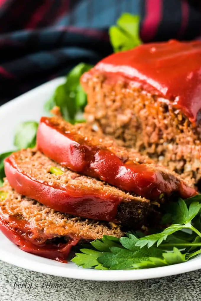 Easy meatloaf recipe sliced on a serving platter.