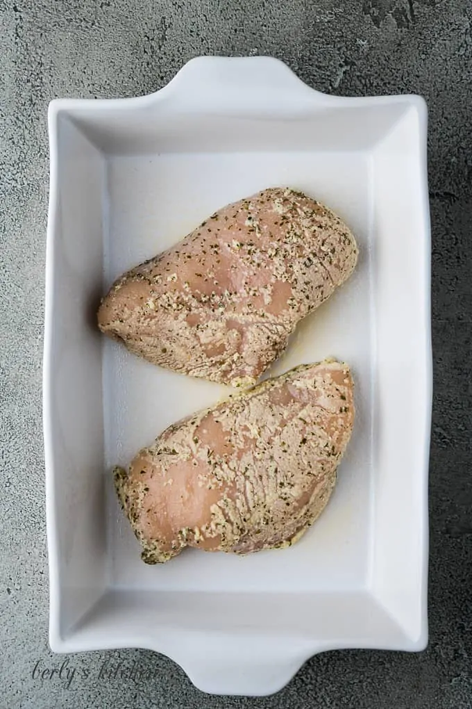 The poultry has been placed in a baking dish to cook.