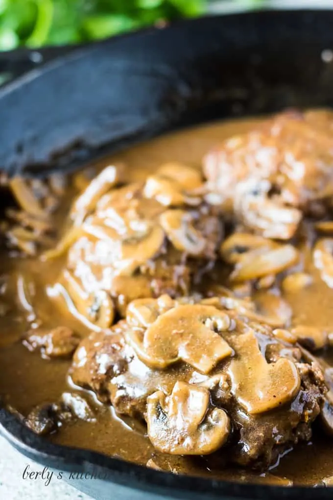 A close up of the finished salisbury steaks with gravy.