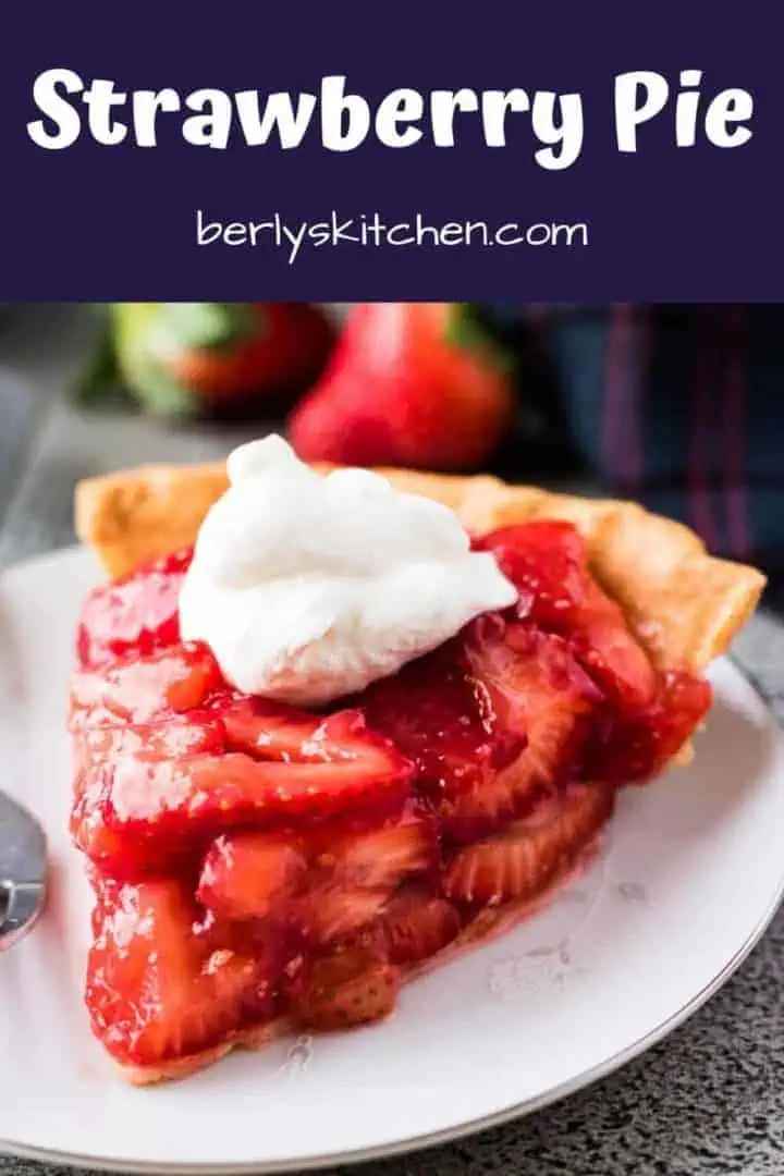 A slice of the strawberry pie topped with whipped cream.