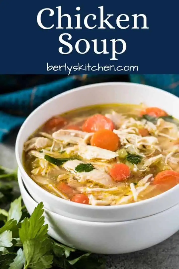 The homemade chicken soup served in a medium sized bowl.