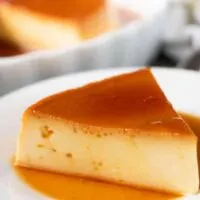 A slice of instant pot flan on a decorative plate.