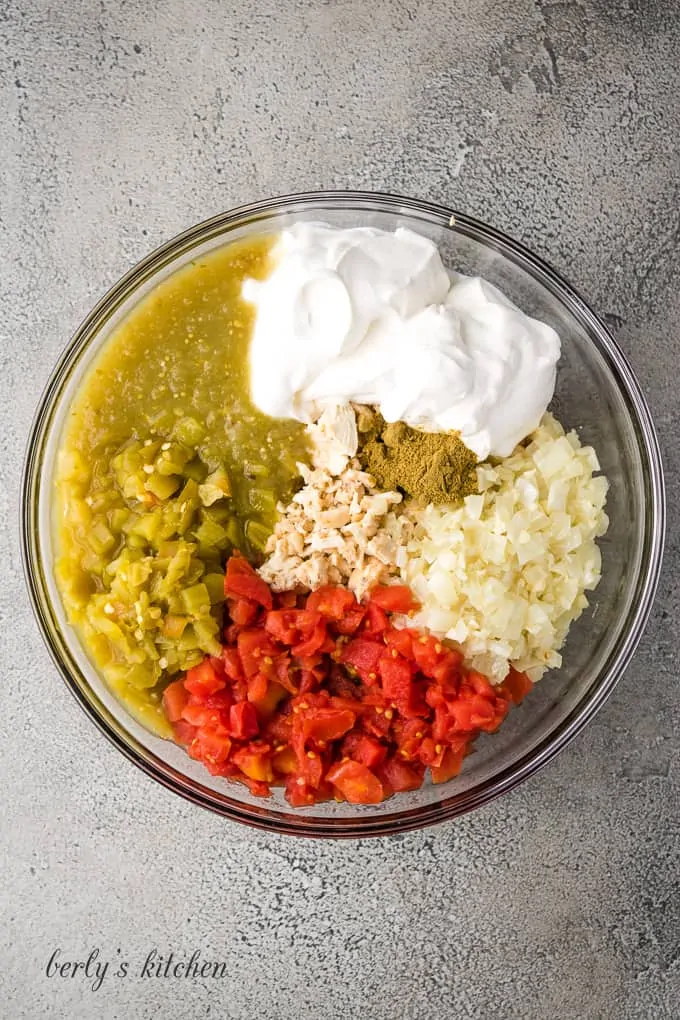 Garlic, chicken and other ingredients in a large mixing bowl.