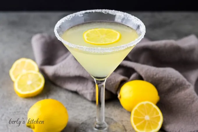 The lemon drop martini in a martini glass rimmed with sugar.