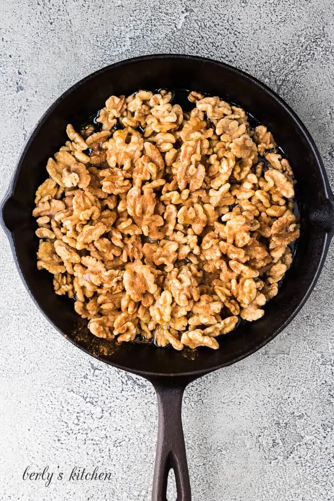 The walnuts and other ingredients in a cast iron skillet.