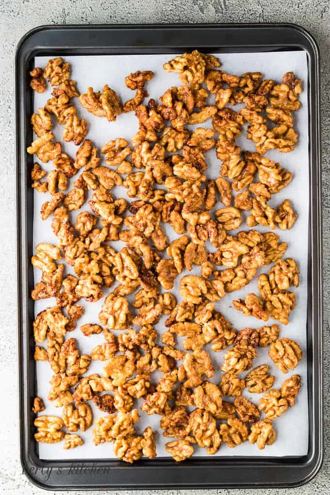 The cooked walnuts cooling on a baking sheet before serving.