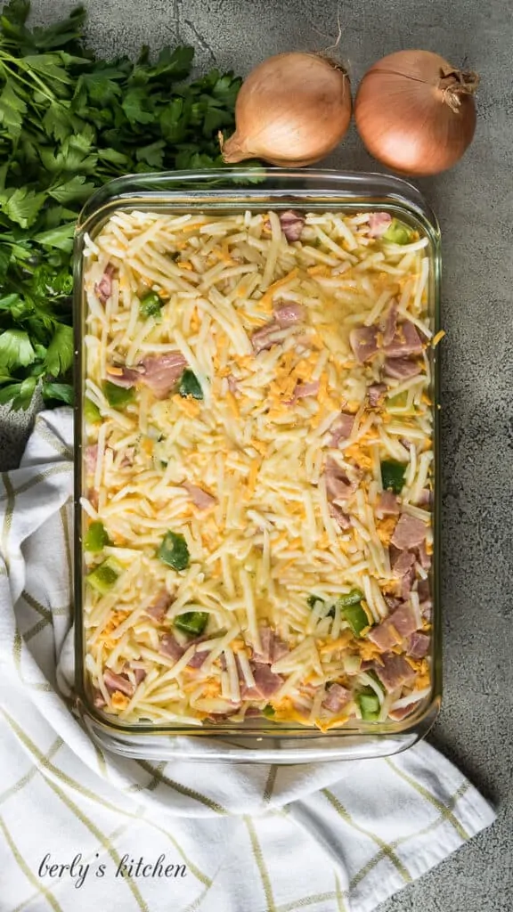 The hash browns mixture and eggs combined in a baking dish.