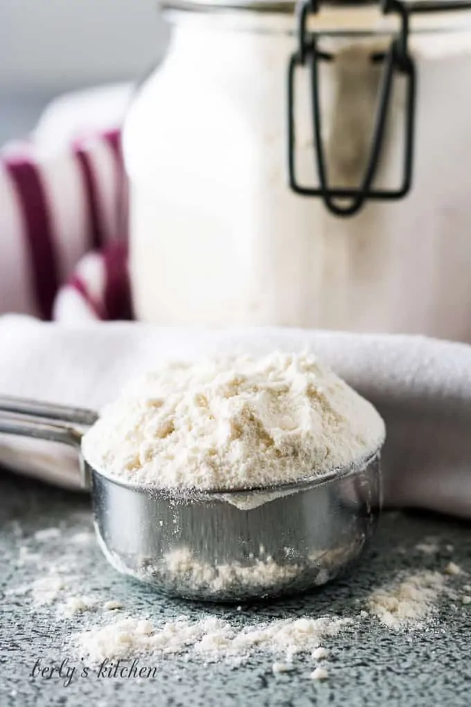 A small measuring cup filled with the baking mix.