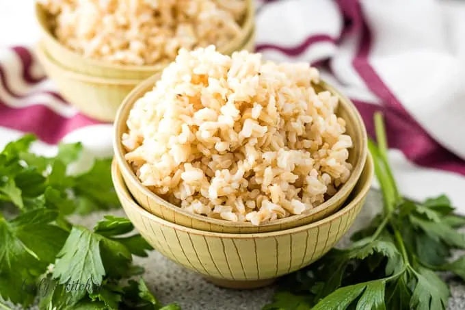 The finished instant pot brown rice in a beige bowl.