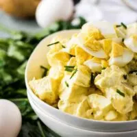 White bowl filled with potato salad.