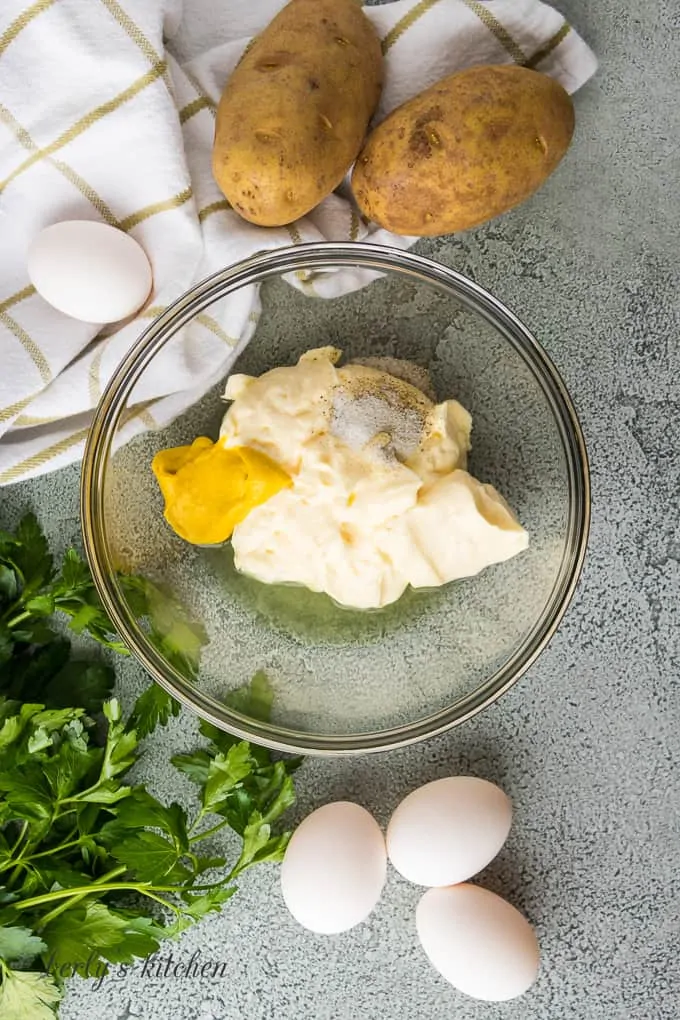 Ariel view of mayonnaise, pickle juice, mustard, salt and pepper for dressing.