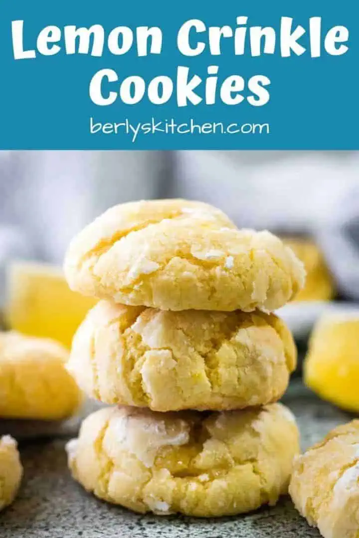 The finished lemon crinkle cookies stacked on a counter.